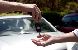 person handing over car keys